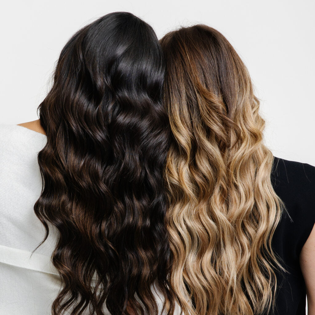 Two women with long wavy hair, each showcasing different stylish hair extensions.